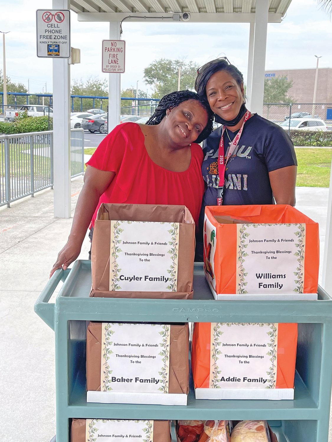 Barbara Johnson (left) with Natasha Twiggs with meals to carry to the Cuyler, williams, Baker, Addie and Howling families.